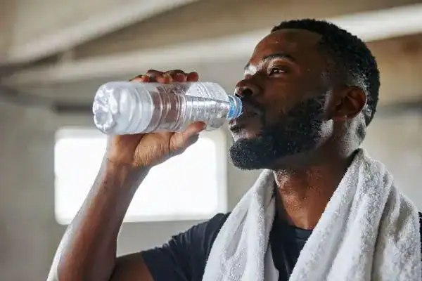 Hydration: The Secret Ingredient for a Toned Stomach and Enhanced Fitness 1 Image of man drinking water to improve hydration Rugby after work out.